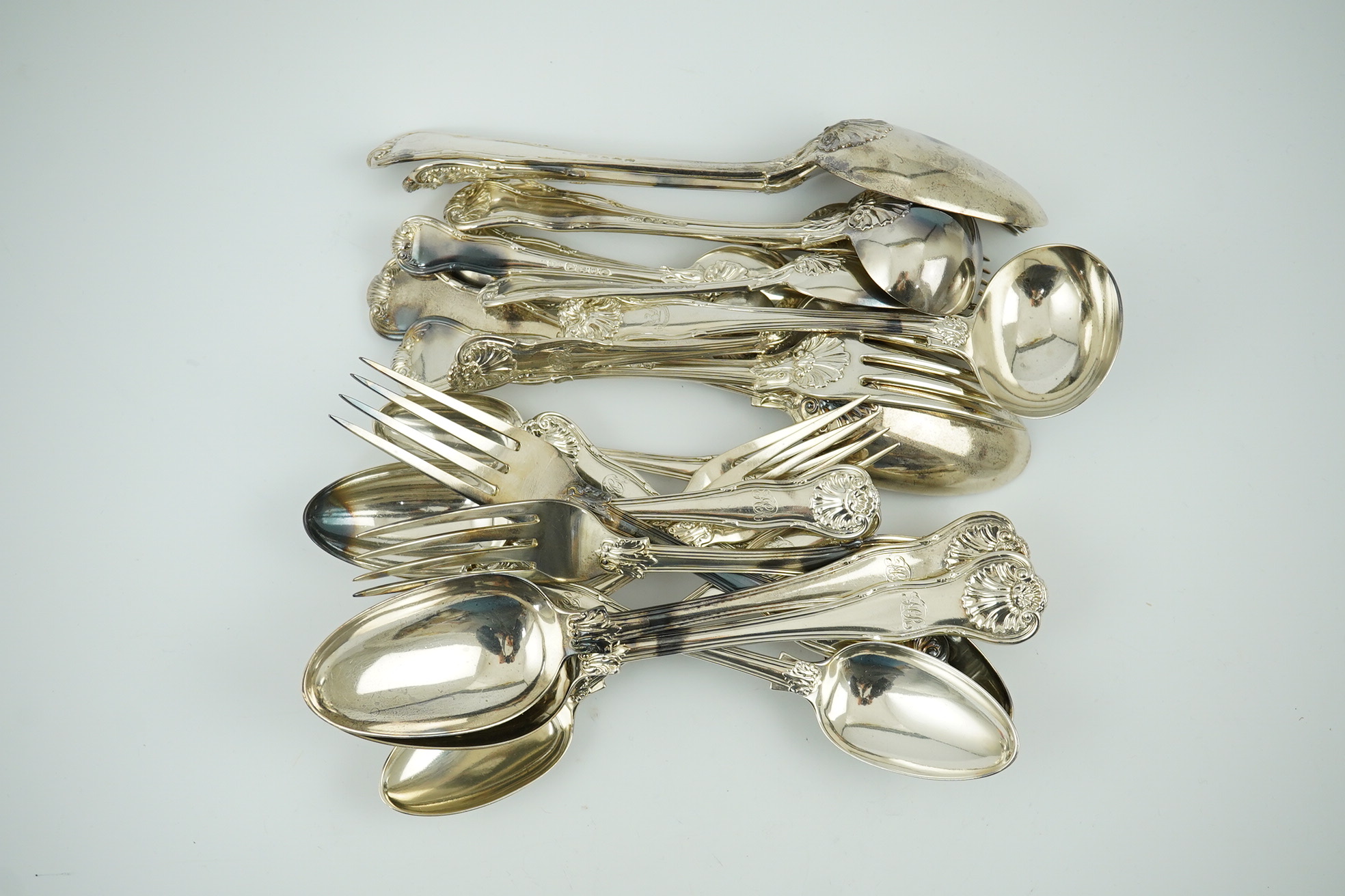 A matched part canteen of George IV and later silver shell scroll pattern flatware